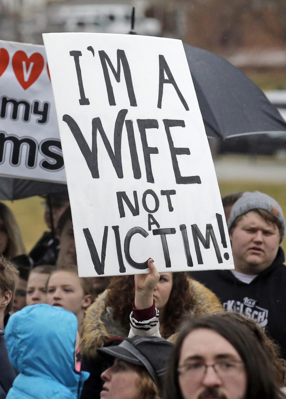 FILE - In this Feb. 10, 2017, file photo, pro-polygamy protesters hold signs during a rally at the state Capitol, in Salt Lake City. Polygamists have lived in Utah since before it became a state, and 85 years after the practice was declared a felony they still number in the thousands. It's even been featured in the long-running reality TV show, "Sister Wives." Now, a state lawmaker says it's time to remove the threat of jail time for otherwise law-abiding polygamists. (AP Photo/Rick Bowmer, File)