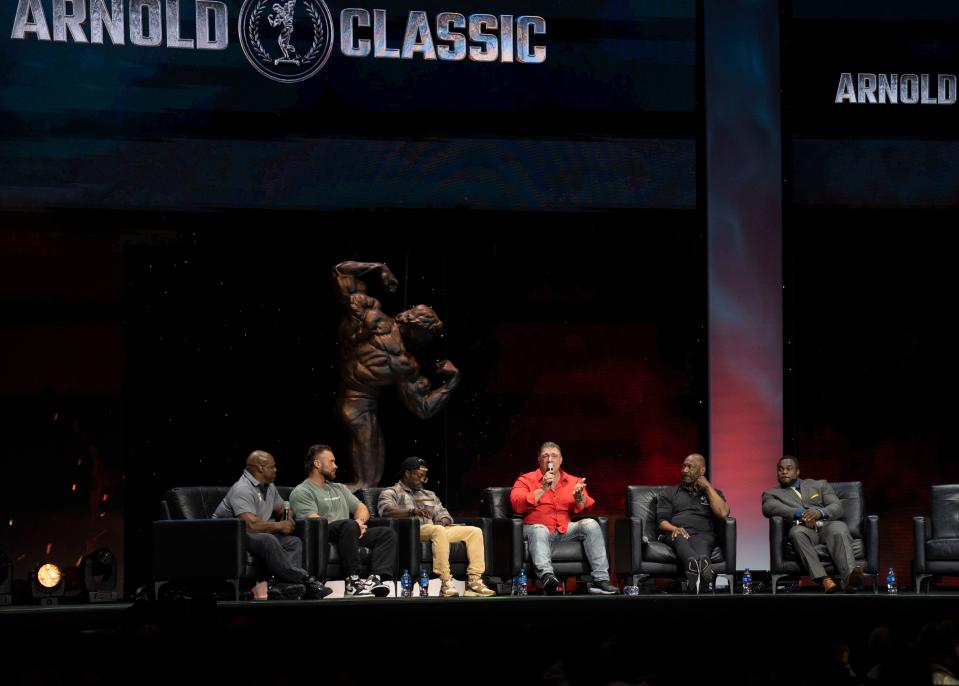 Emcee Bob Cicherillo, center, speaks during a roundtable with Arnold Schwarzenegger (not pictured) and other bodybuilders on Sunday, the final day of The Arnold Sports Festival at the Greater Columbus Convention Center.