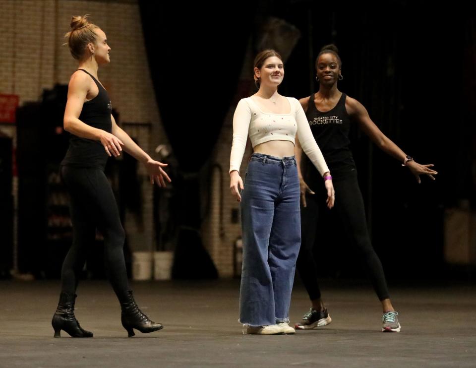 Annabelle Park is escorted on the Radio City Music Hall stage by Rockettes Katelyn Gaffney and LaTarika Pierce during a rehearsal for the Garden of Dreams Talent Show in New York, April 11, 2023. Park, sponsored by the Maria Fareri Children's Hospital will play the piano and sing, "She Used to be Mine".