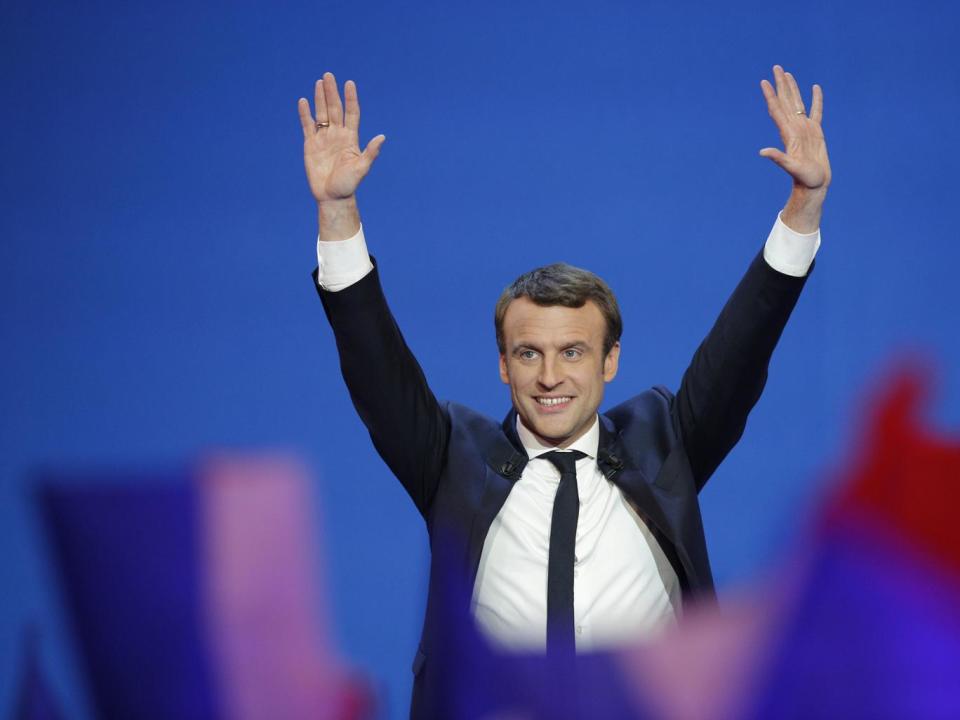 Emmanuel Macron takes to the stage after the first results of the election were announced (AP)