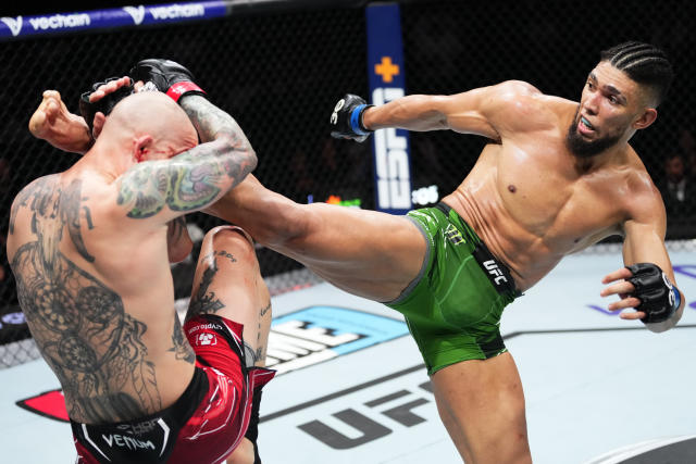 Johnny Walker (right) kicks Anthony Smith in their light heavyweight fight during UFC on ABC 4 on May 13, 2023 in Charlotte, North Carolina. (Jeff Bottari/Zuffa LLC via Getty Images)