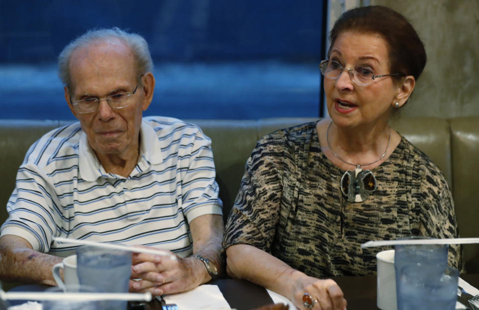 In this, Monday, Oct. 7, 2019 photo, Vera Karliner, right, speaks during an interview with The Associated Press in Aventura, Fla., along with her husband Herb, left, who was on the ship named the St. Louis that was full of Jewish refugees but was turned away from the U.S. in 1939. Aging Holocaust survivors are trying to recover insurance benefits that were never honored by Nazi-era companies, which could be worth billions of dollars. The companies have demanded original paperwork, such as death certificates, that were not available after World War II. The survivors want to take insurance companies to court in the U.S. to recover the money, but it would take an act of Congress to allow it. (AP Photo/Wilfredo Lee)