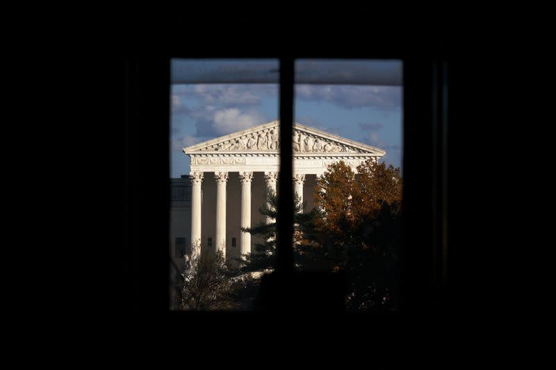 FILE PHOTO: The U.S. Supreme Court building is seen behind a window in Washington