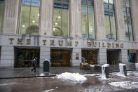 People walk by The Trump Building office building at 40 Wall Street in New York on Friday, Jan. 7, 2022. The New York attorney general’s office says, Tuesday, Jan. 18, its civil investigation has uncovered evidence that former President Donald Trump's company used “fraudulent or misleading” asset valuations to get loans and tax benefits. (AP Photo/Ted Shaffrey)