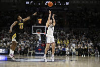 UConn forward Alex Karaban (11) makes his career-high 26th point with a three-point basket over Arkansas-Pine Bluff forward Lonnell Martin Jr. (23) in the second half of an NCAA college basketball game, Saturday, Dec. 9, 2023, in Storrs, Conn. (AP Photo/Jessica Hill)