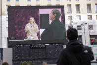 A giant screen streams a Prada fashion live during an interview with Miuccia Prada and Raf Simons, during the Milan's fashion week in Milan, Italy, Sunday, Jan. 17, 2021. (AP Photo/Luca Bruno)