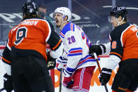 New York Rangers' Chris Kreider (20) reacts after scoring a goal as Philadelphia Flyers' Ivan Provorov (9) and Robert Hagg (8) look on during the second period of an NHL hockey game, Wednesday, Feb. 24, 2021, in Philadelphia. (AP Photo/Matt Slocum)