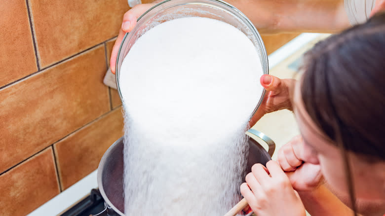 Sugar pouring into water