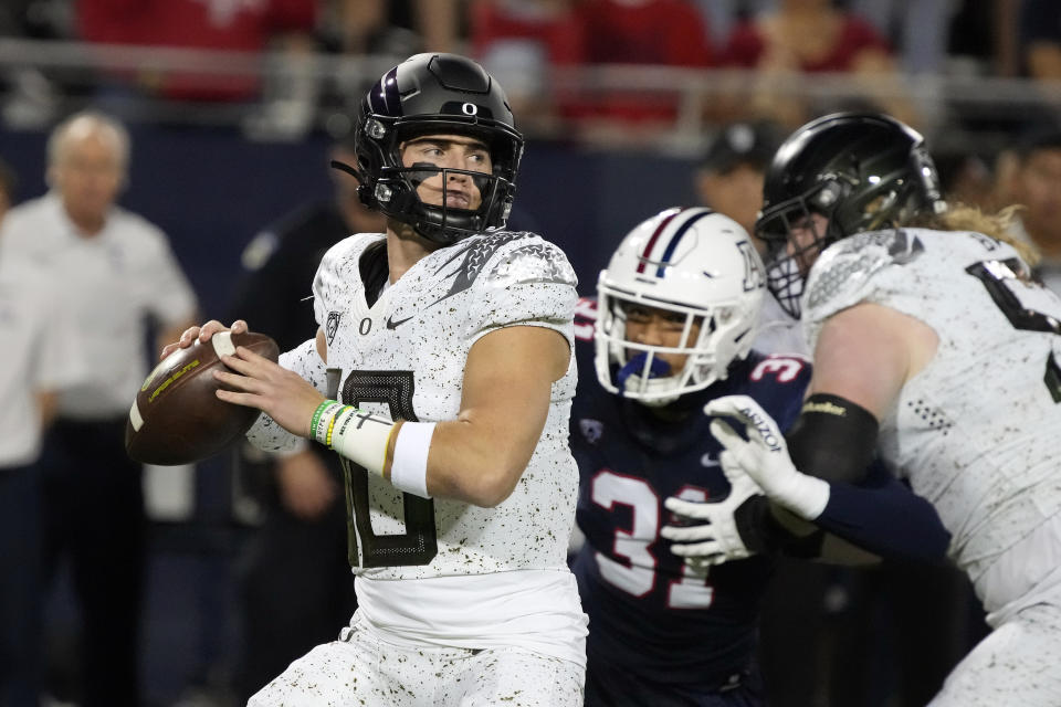 Oregon quarterback Bo Nix (10) looks for a receiver during the first half of the team's NCAA college football game against Arizona, Saturday, Oct. 8, 2022, in Tucson, Ariz. (AP Photo/Rick Scuteri)