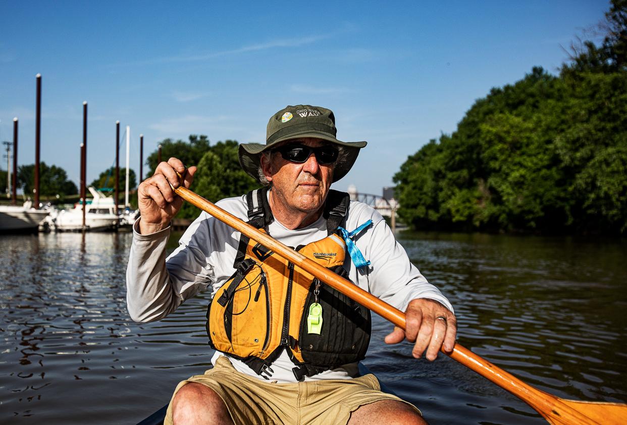 Environmental educator David Wicks rows his canoe past Towhead Island and RiverPark Place Marina, heading to Beargrass Creek, Louisville’s three-forked urban waterway with a legacy of neglect. June 16, 2022