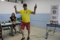 A man gestures after voting in a run-off election pitting President Jair Bolsonaro against former President Luiz Inacio Lula da Silva, in Sao Paulo, Brazil, Sunday, Oct. 30, 2022. (AP Photo/Andre Penner)