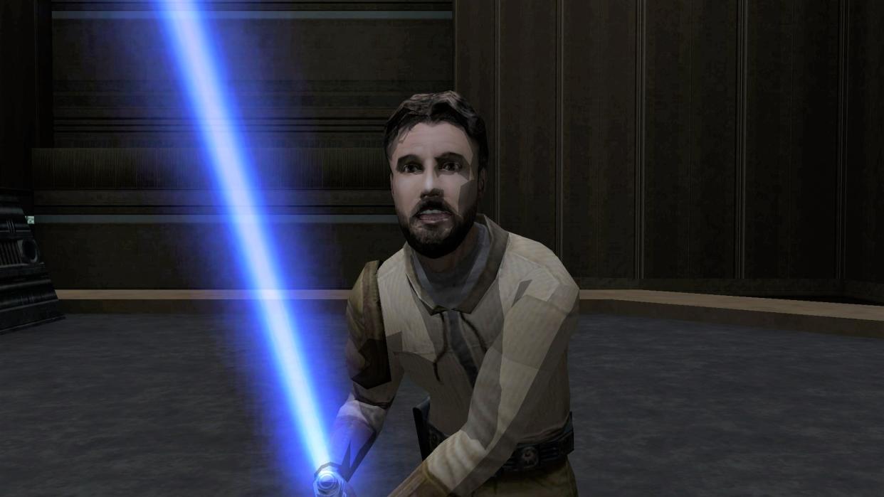  Kyle Katarn looking at you while holding his blue lightsaber. 