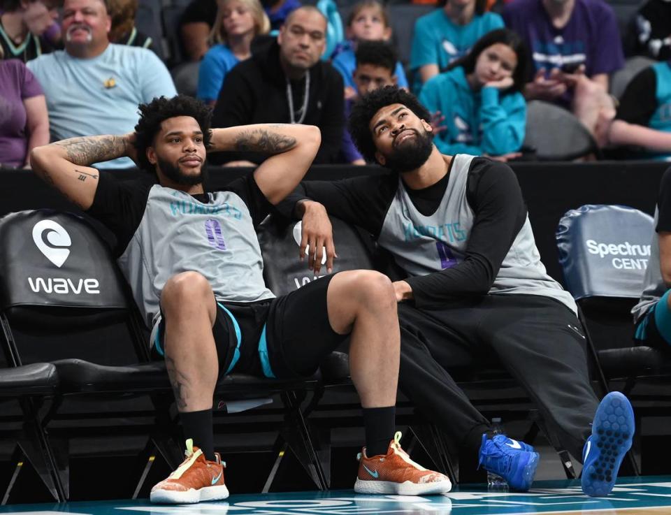 Charlotte Hornets forward Miles Bridges, left and center Nick Richards, right, relax along the sideline during the team’s Purple and Teal scrimmage at Spectrum Center in Charlotte, NC on Saturday, October 7, 2023.