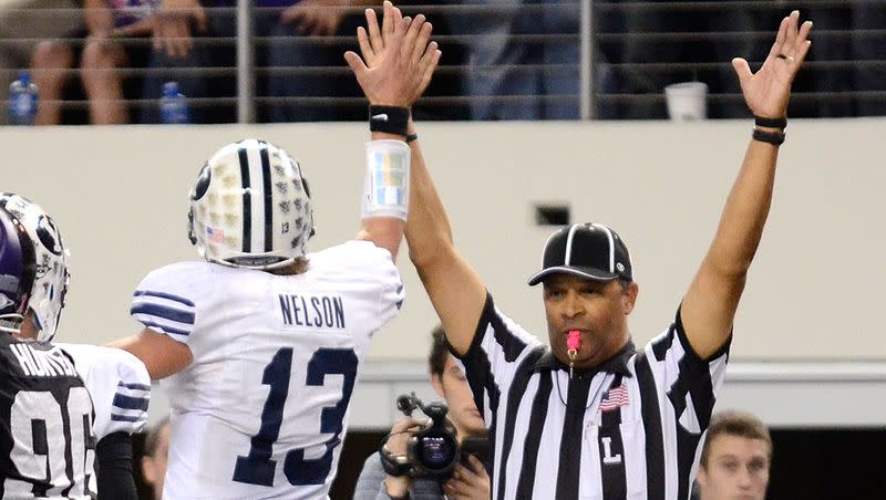 BYU’s Riley Nelson gives the referee a high-five after scoring during a game against TCU at Cowboys Stadium on October 28, 2011 in Arlington, Texas. The two teams meet again this Saturday afternoon in Fort Worth.