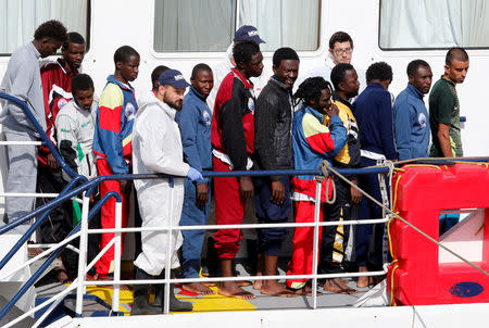 Migrants wait to disembark from MOAS vessel Phoenix in the Sicilian harbour of Catania, Italy, May 6, 2017. REUTERS/Antonio Parrinello