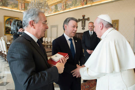 Pope Francis (R) meets Colombia's President Juan Manuel Santos (C) and former president Alvaro Uribe (L) at the Vatican December 16, 2016. Osservatore Romano/Handout via REUTERS