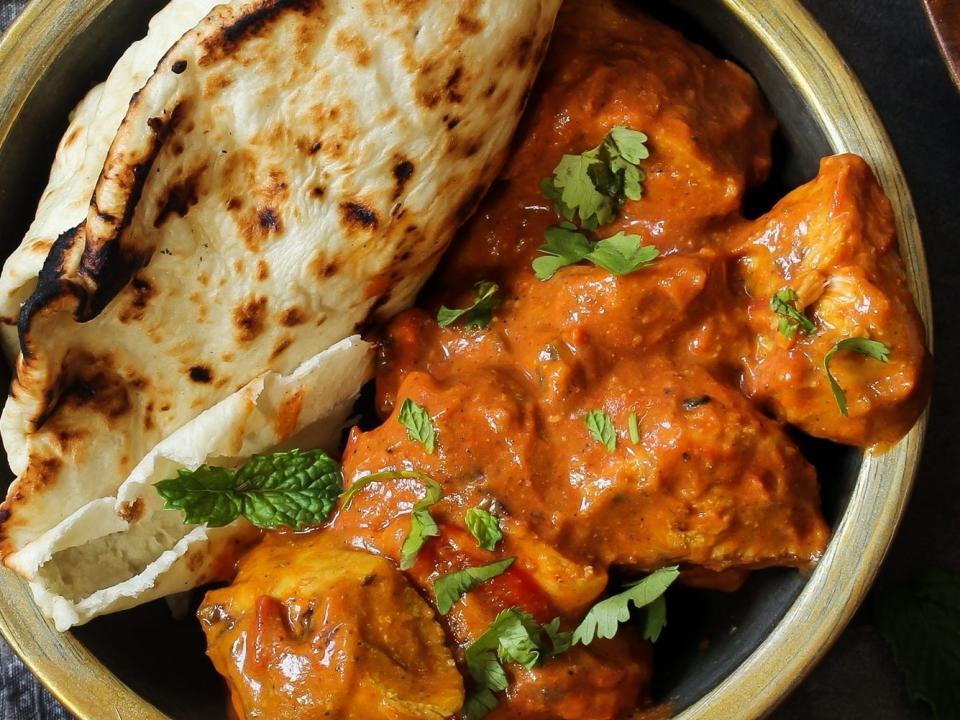 Butter chicken served with naan bread