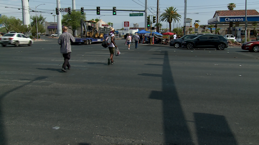 Several people cross the intersection of Flamingo Road and Maryland Parkway on Friday morning. (KLAS)