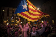 <p>Pro-independence supporters cheer and wave “estelada” or pro independence flags in the square outside the Palau Generalitat in Barcelona, Spain, after Catalonia’s regional parliament passed a motion with which they say they are establishing an independent Catalan Republic, Friday, Oct. 27, 2017. (Photo: Santi Palacios/AP) </p>