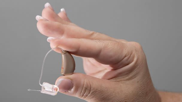 PHOTO: Jennifer Nealon, Marketing Director at Hear Again America, holds a hearing aid that they sell, Oct. 19, 2021, in Boca Raton, Fla.  (Joe Raedle/Getty Images)