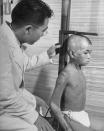 Caption from LIFE. "Flash-burned boy is measured by pediatrician. Growth of such children is checked regularly." Hiroshima, 1949. (Carl Mydans—Time & Life Pictures/Getty Images) <br> <br> <a href="http://life.time.com/history/carl-mydans-hiroshima/#1" rel="nofollow noopener" target="_blank" data-ylk="slk:Click here;elm:context_link;itc:0;sec:content-canvas" class="link ">Click here</a> to see the full collection at LIFE.com