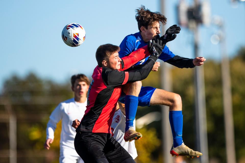 Marian's Harley Pankiewicz (7) redirects a pass past West Lafayette's Andrew Von Werder (1) to score during the Marian vs. West Lafayette regional championship soccer game Saturday, Oct. 15, 2022 at Marian High School.