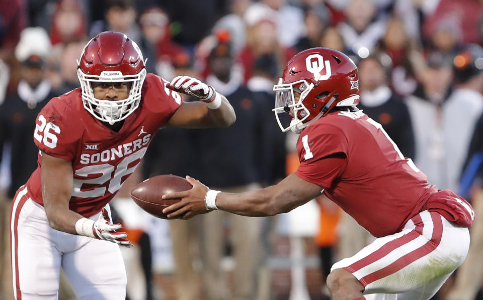 Oklahoma quarterback Kyler Murray (1) hands off the ball to Oklahoma running back Kennedy Brooks (26) during a play against Oklahoma State in the second half of an NCAA college football game in Norman, Okla., Saturday, Nov. 10, 2018. Oklahoma won 48-47. (AP Photo/Alonzo Adams)