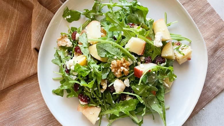 Apple walnut salad on white plate