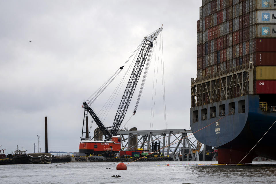 The Dali, right, a massive container ship from Singapore, still sits amid the wreckage and collapse of the Francis Scott Key Bridge in the Baltimore port, Monday, April 1, 2024. (Kaitlin Newman/The Baltimore Banner via AP)