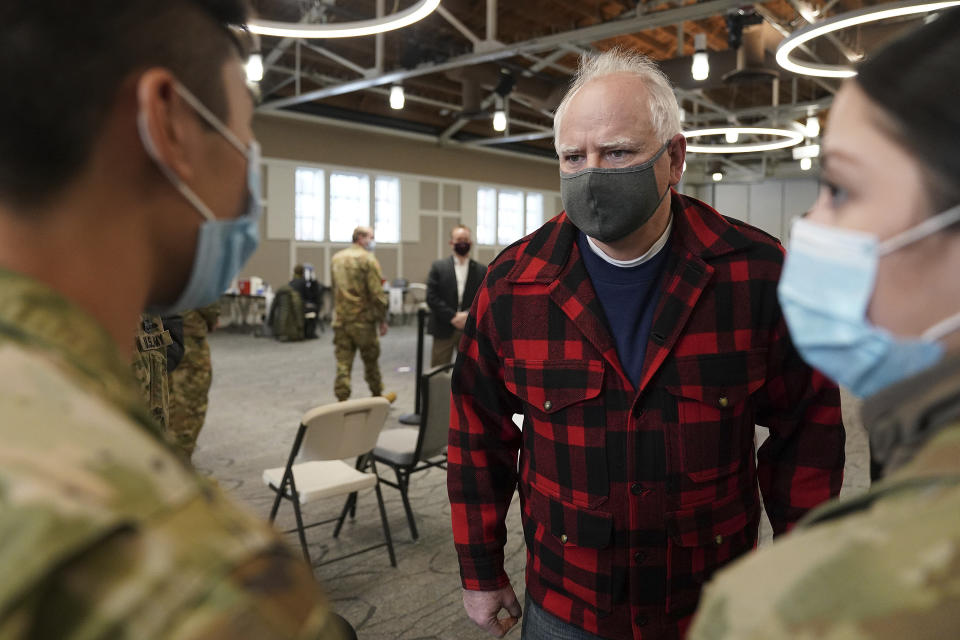Gov. Tim Walz talked with members of the National Guard who were helping manage the people there for appointments to get a COVID-19 vaccine Thursday, Jan. 28, 2021 at the Earle Brown Heritage Center in Brooklyn Center. (Anthony Souffle/Star Tribune via AP)