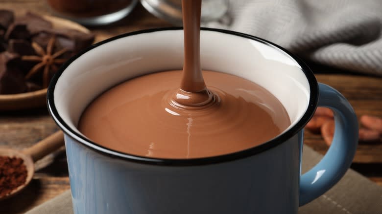 Hot chocolate poured into mug