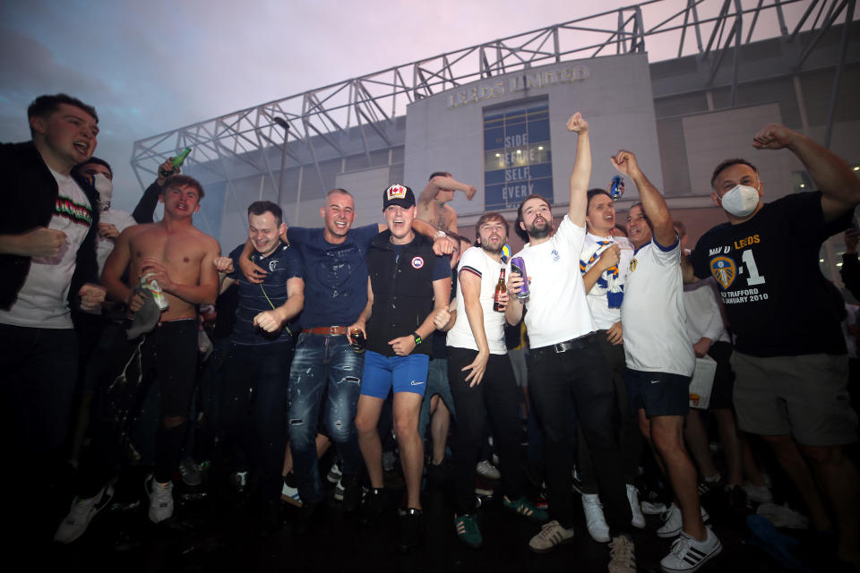 Leeds United fans celebrate outside Elland Road after Huddersfield Town beat West Bromwich Albion to seal their promotion to the Premier League.