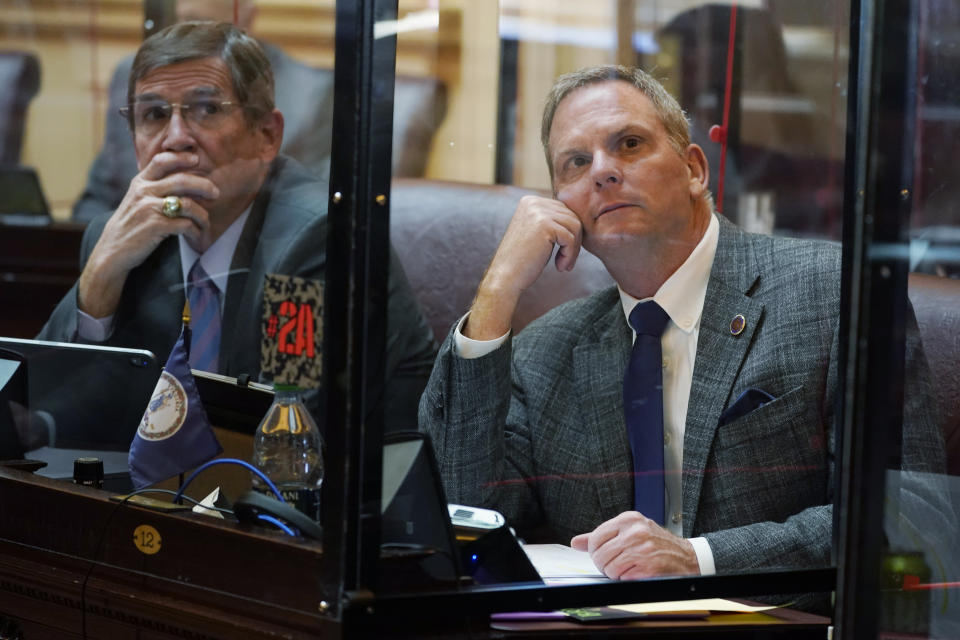 Virginia State Sen. Bill DeSteph, R-Virginia Beach, right, along with Sen. John Cosgrove, R-Chesapeake, left, look at the vote tally board during the Senate session at the Capitol Thursday Jan. 27, 2022, in Richmond, Va. A Virginia Senate committee killed legislation, sponsored by DeSteph, that would have required parental consent for students to check out sexually explicit books from school libraries. (AP Photo/Steve Helber)