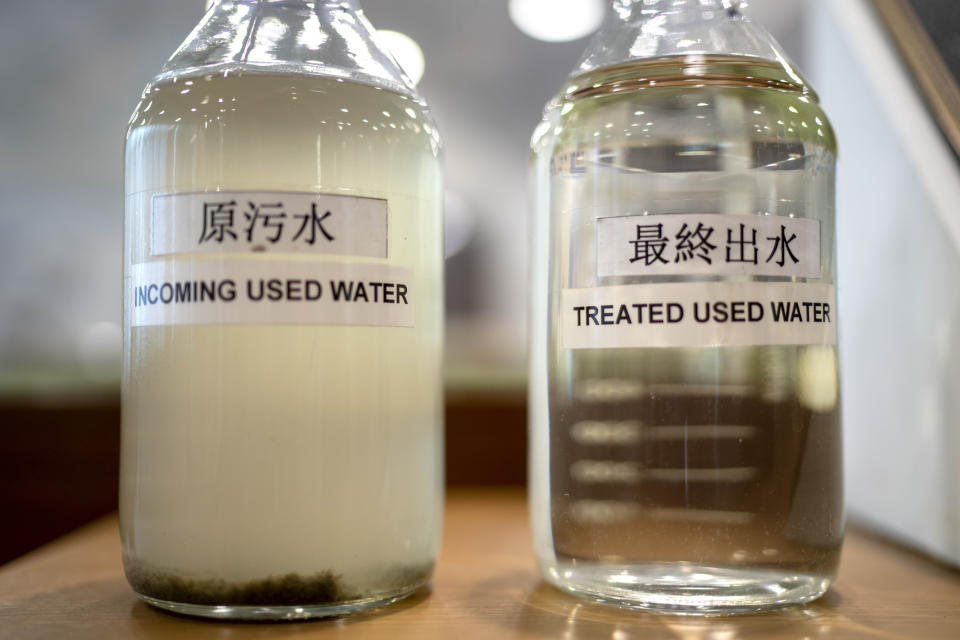 Two bottles on display show the difference between incoming used water and treated used water after processing at the Changi Water Reclamation Plant in Singapore, Thursday, July 20, 2023. Dubbed "NEWater", the treated wastewater now provides Singapore 40% of its water, with the government hoping to increase capacity to 55% of demand in years to come. (AP Photo/David Goldman)