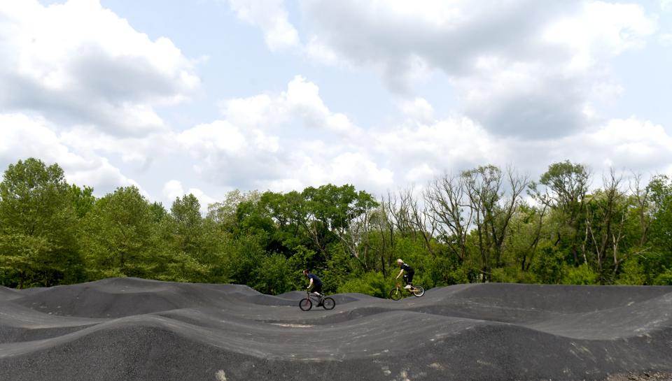 Kyler McCammon, 17, of Sebring and Cody Mullins, 21, left, of Alliance ride the new pump track at Memorial Park, which was recently opened for bike riders. Tuesday, May 23, 2023.