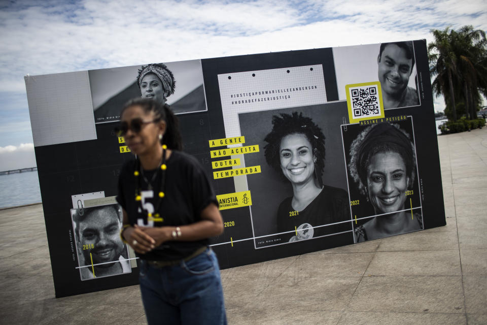 An installation set up by Amnesty International shows images of councilwoman Marielle Franco and her driver Anderson Gomes, to mark five years since their murders, still under investigation, outside the Museum of Tomorrow in Rio de Janeiro, Brazil, Tuesday, March 14, 2023. (AP Photo/Bruna Prado)