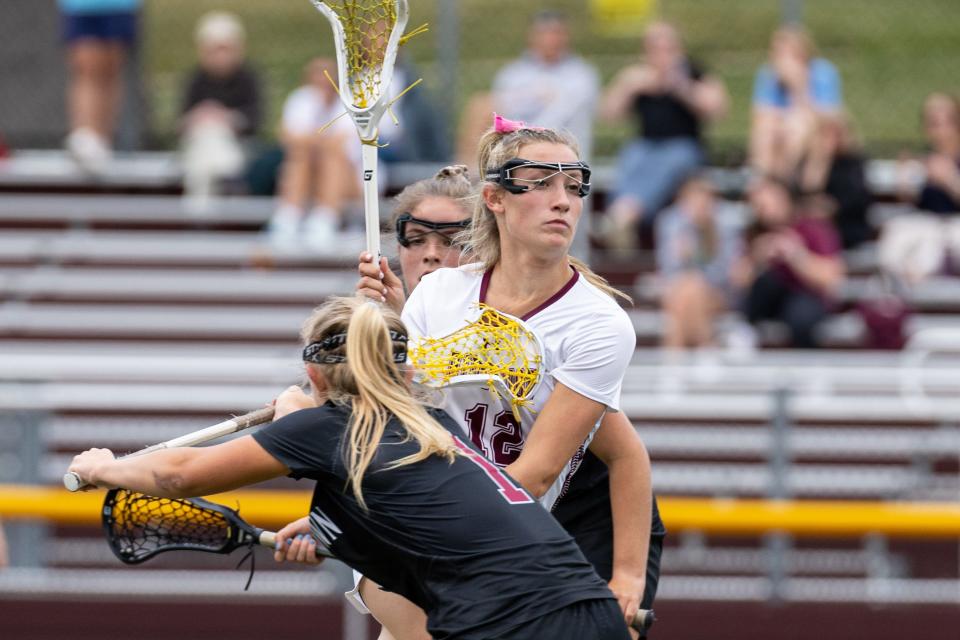 Jun 5, 2023; Ridgewood, New Jersey, USA; Ridgewood Kiera Schwartz (12) moves the ball against Morristown during the North Group 4 girls lacrosse final at Ridgewood High School. Mandatory Credit: Tom Salus-The Record