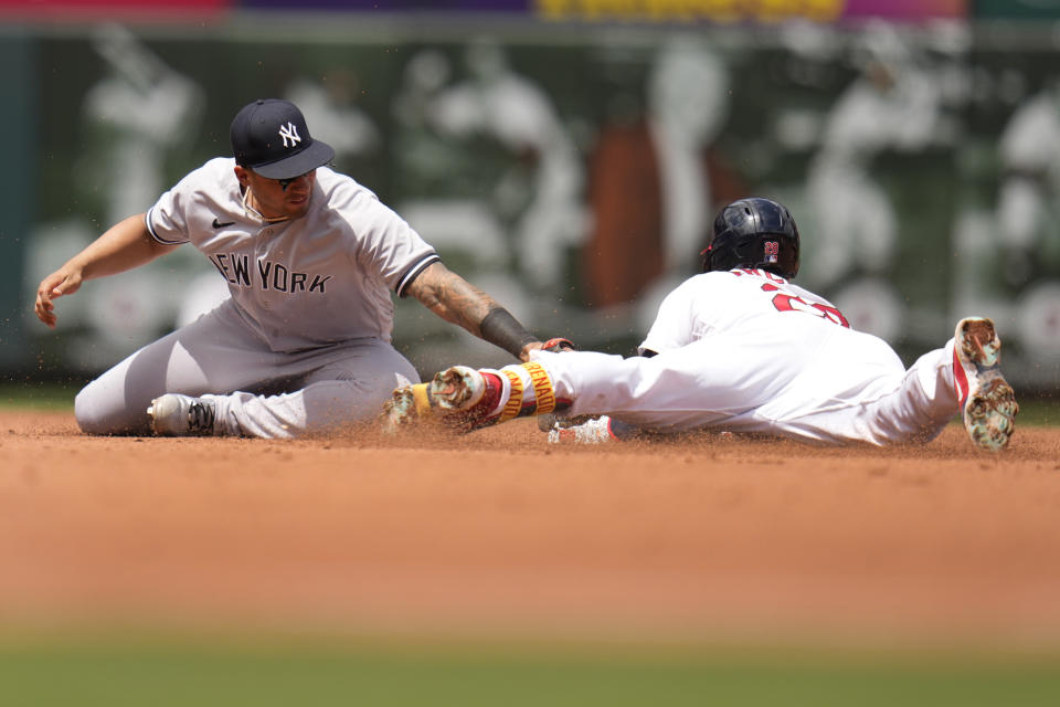 St. Louis Cardinals' Nolan Arenado, right, is safe at second ahead of the tag from New York Yankees second baseman Gleyber Torres during the fourth inning of a baseball game Sunday, July 2, 2023, in St. Louis. (AP Photo/Jeff Roberson)