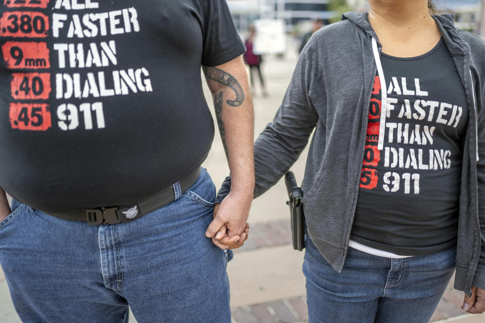 Albuquerque residents Michael Caldwell, left, and his wife Natasha Caldwell attend a Second Amendment Protest in response to Gov. Michelle Lujan Grisham's recent public health order suspending the conceal and open carry of guns in and around Albuquerque for 30-days, Tuesday, Sept. 12, 2023, in Albuquerque, N.M. Natasha said "we came to stand for the constitution and out of anger about what's happening with this health order." (AP Photo/Roberto E. Rosales)