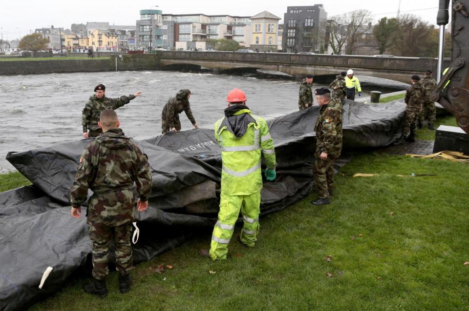 Flood barriers are erected in Galway City in preparation for Storm Brian (PA)