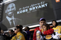 Fans mourn the loss of Kobe Bryant in front of La Live across from Staples Center, home of the Los Angeles Lakers in Los Angeles on Sunday, Jan. 26, 2020. Bryant, the 18-time NBA All-Star who won five championships and became one of the greatest basketball players of his generation during a 20-year career with the Los Angeles Lakers, died in a helicopter crash Sunday. (Keith Birmingham/The Orange County Register via AP)