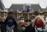 A person holds up a a portrait of Samuel Paty as they gather on Republique square in Lille, northern France, Sunday Oct. 18, 2020. Demonstrators in France on Sunday took part in gatherings in support of freedom of speech and in tribute to a history teacher who was beheaded near Paris after discussing caricatures of Islam’s Prophet Muhammad with his class. (AP Photo/Michel Spingler)