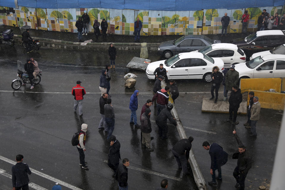 Protestors block a road after authorities raised gasoline prices, in Tehran, Iran, Saturday, Nov. 16, 2019. Protesters angered by Iran raising government-set gasoline prices by 50% blocked traffic in major cities and occasionally clashed with police Saturday after a night of demonstrations punctuated by gunfire. (Majid Khahi/ISNA via AP)