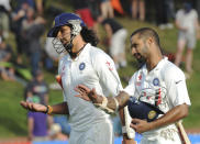 India’s Ishant Sharma, left and Shikar Dhawan leave the pitch at the end of play against New Zealand on the first day of the second cricket test in Wellington, New Zealand, Friday, Feb. 14, 2014.