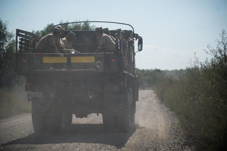 Romanian Army soldiers ride in a military truck after building a bomb shelter in the village of Plauru, Danube Delta, Romania, on September 12, 2023. <em>Photo by MIHAI BARBU/AFP via Getty Images</em>