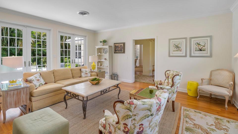 French doors in the living room provide access to a patio area by the pool.