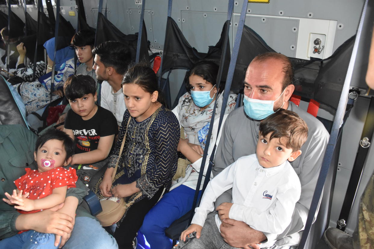 A family sits on a Turkish Armed Forces aircraft during evacuation in Kabul. (Aykut Karadag/Anadolu Agency via Getty Images)