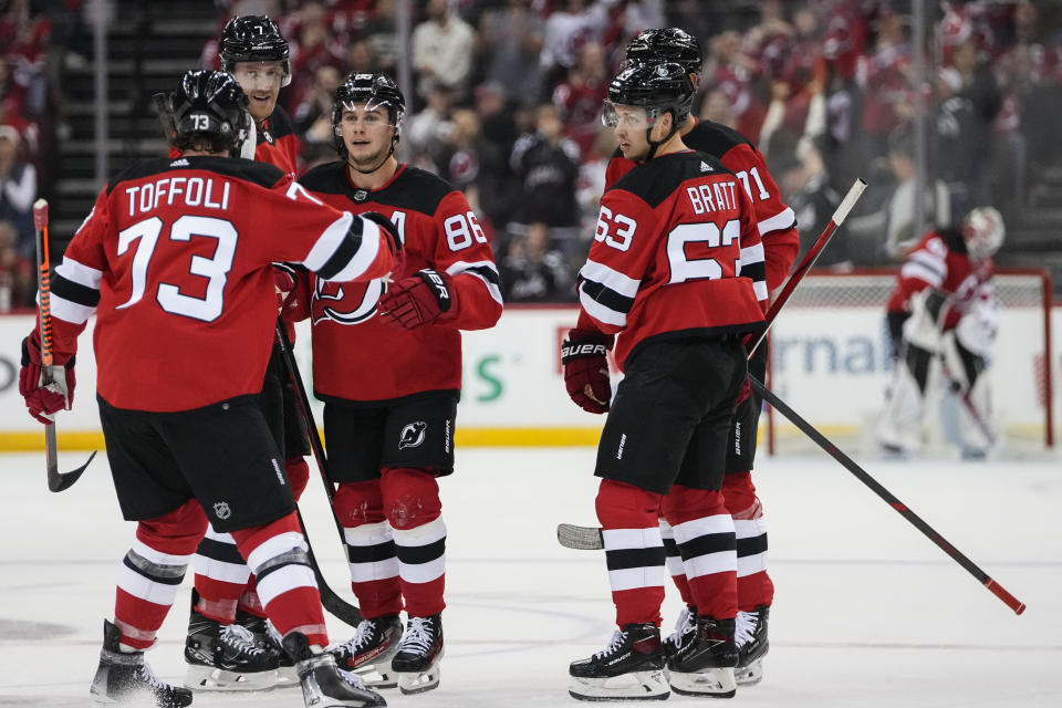 New Jersey Devils' Jack Hughes (86) celebrates with Tyler Toffoli (73), Jesper Bratt (63), Jonas Siegenthaler (71) and Dougie Hamilton (7) after scoring a goal against the Detroit Red Wings during the second period of an NHL hockey game Thursday, Oct. 12, 2023, in Newark, N.J. (AP Photo/Frank Franklin II)