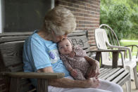 Tressie Corsi sits with her great great granddaughter Amelia Hollis on the porch of the house she has owned in Johnstown, Ohio, since 1972 to that she is giving up to make way for an Intel manufacturing plant during an interview Monday, June 20, 2022. Corsi and her husband raised four children and welcomed multiple generations of grandchildren and great-grandchildren, including some who lived right next door. (AP Photo/Paul Vernon)