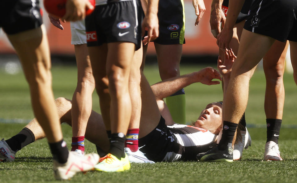 Nathan Murphy, pictured here after copping a heavy head knock in the AFL grand final last year.